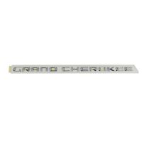 Emblem på sidan av dörren *Grand Cherokee*